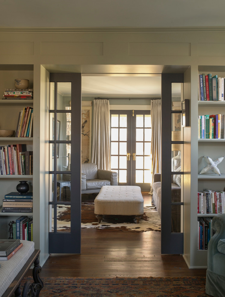 Idee per un soggiorno country chiuso con libreria, pareti grigie e pavimento in legno massello medio