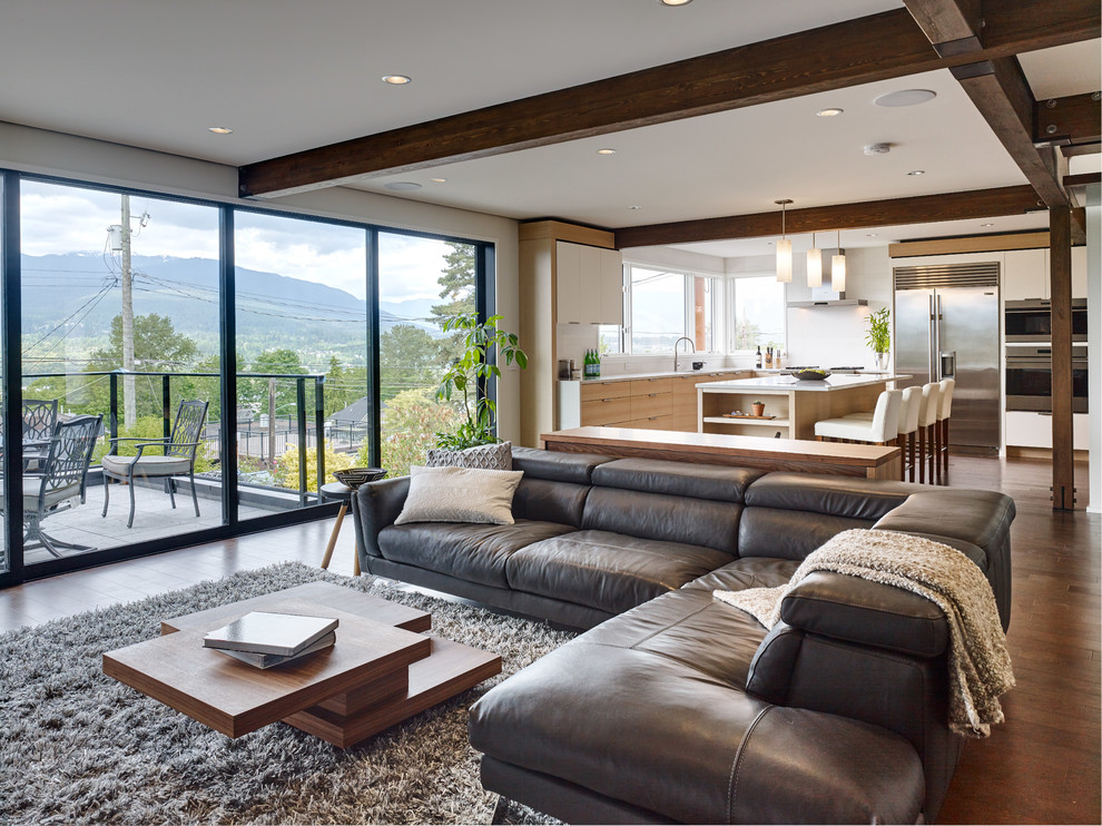 Contemporary grey and brown open plan living room in Vancouver with dark hardwood flooring and brown floors.