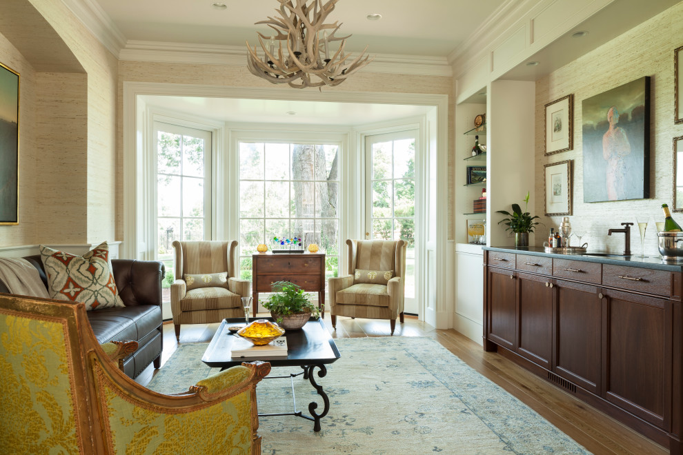 Klassisches Wohnzimmer mit beiger Wandfarbe, braunem Holzboden, braunem Boden und Tapetenwänden in Sonstige