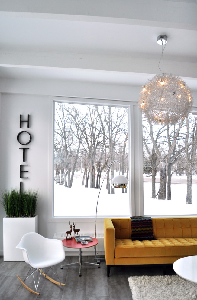 Mid-century modern living room photo in Other with white walls