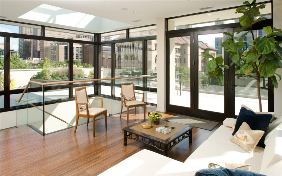 Example of a large trendy open concept bamboo floor living room design in Chicago with white walls