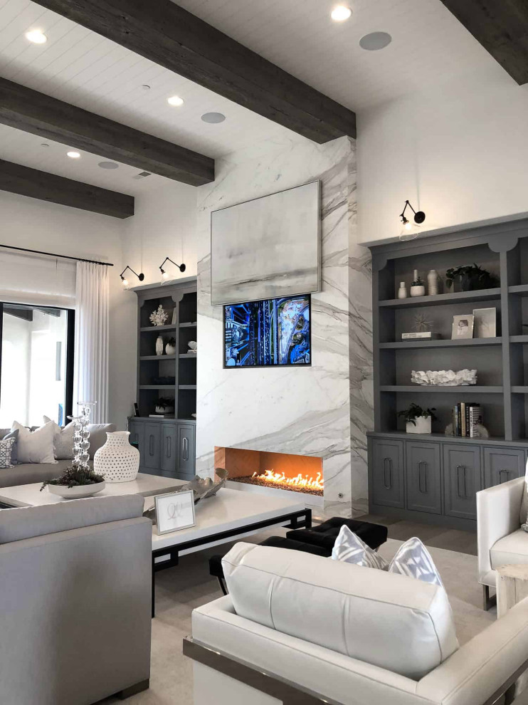 Idée de décoration pour un grand salon nordique ouvert avec un mur blanc, parquet clair, une cheminée standard, un manteau de cheminée en pierre, un téléviseur encastré et un sol gris.