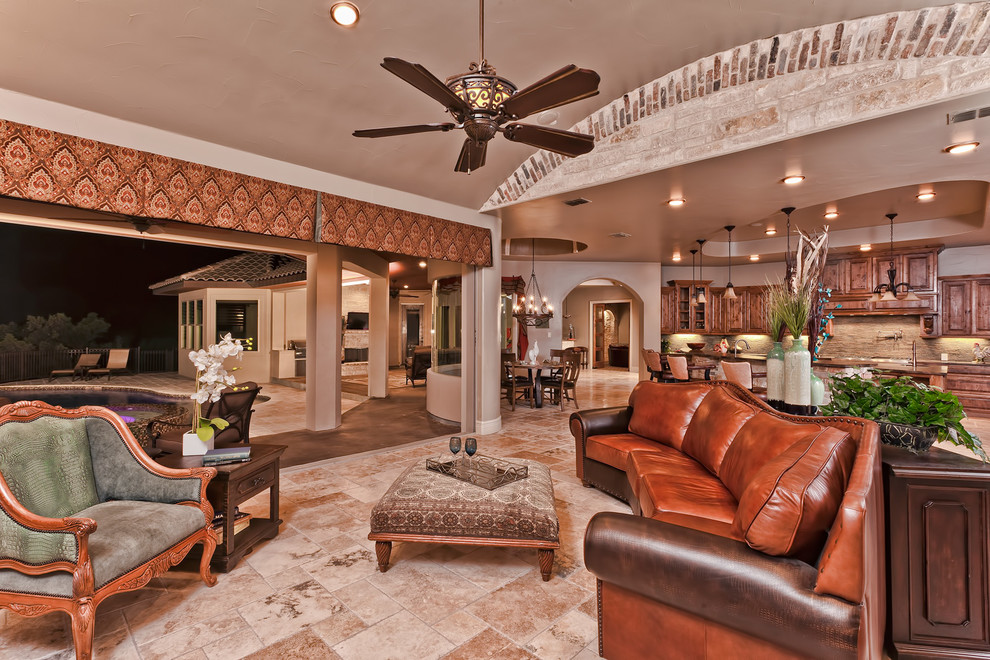 Large mediterranean open plan living room in Austin with beige walls, porcelain flooring and beige floors.