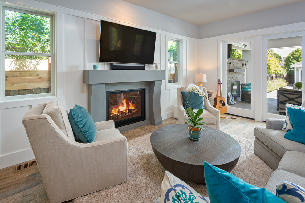 Inspiration for a traditional living room in San Francisco with a concrete fireplace surround and a wall mounted tv.