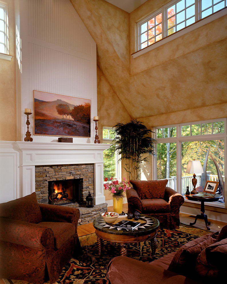 Источник вдохновения для домашнего уюта: гостиная комната в классическом стиле с бежевыми стенами, стандартным камином и фасадом камина из камня