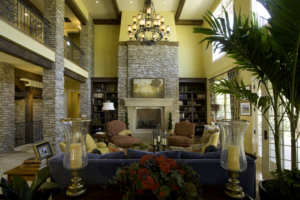 Design ideas for a mediterranean living room in Denver with yellow walls and a standard fireplace.