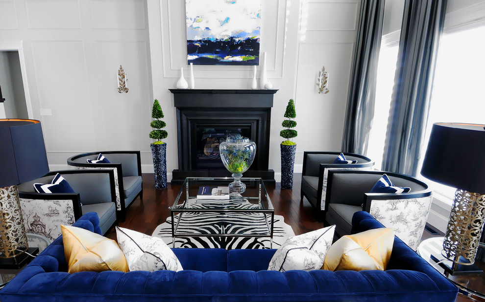 Example of a trendy dark wood floor and brown floor living room design in Other with white walls and a standard fireplace