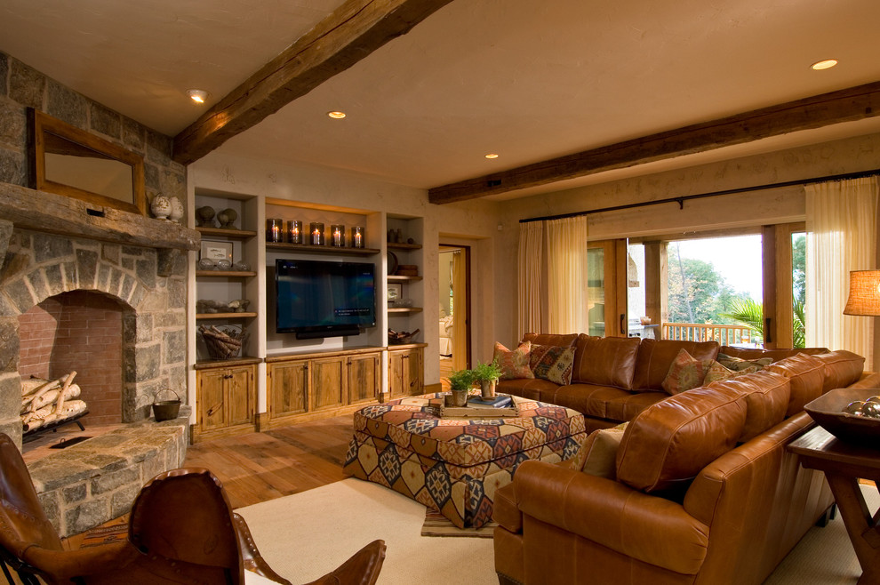 Rustic living room curtain in New York with a corner fireplace and a stone fireplace surround.