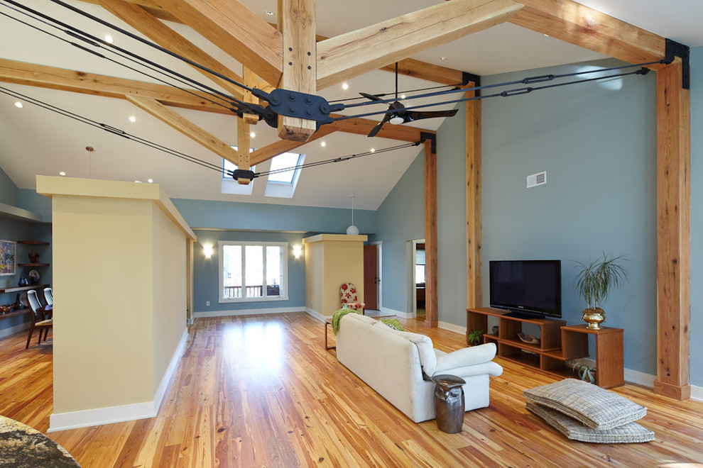 Idee per un grande soggiorno design aperto con pareti blu, parquet chiaro e TV autoportante