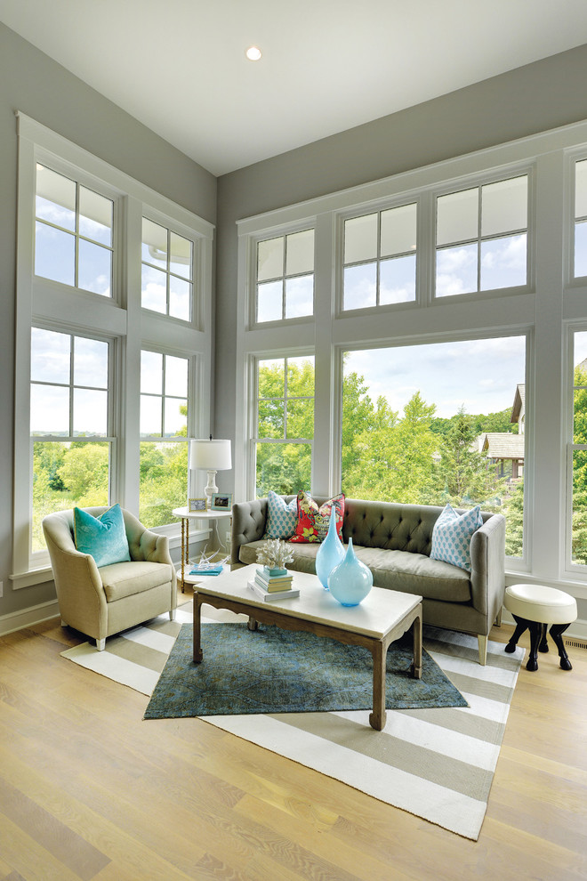 Transitional open concept medium tone wood floor living room photo in Minneapolis with gray walls