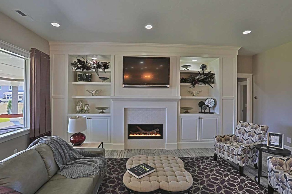 Example of a transitional open concept porcelain tile living room design in Seattle with gray walls, a standard fireplace, a tile fireplace and a wall-mounted tv
