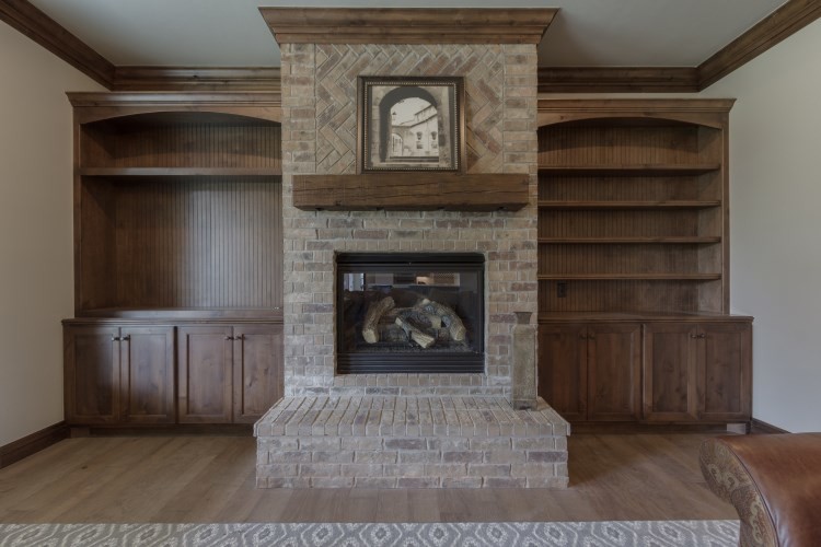 Example of a mid-sized transitional open concept light wood floor living room design in Oklahoma City with gray walls, a standard fireplace, a brick fireplace and a wall-mounted tv