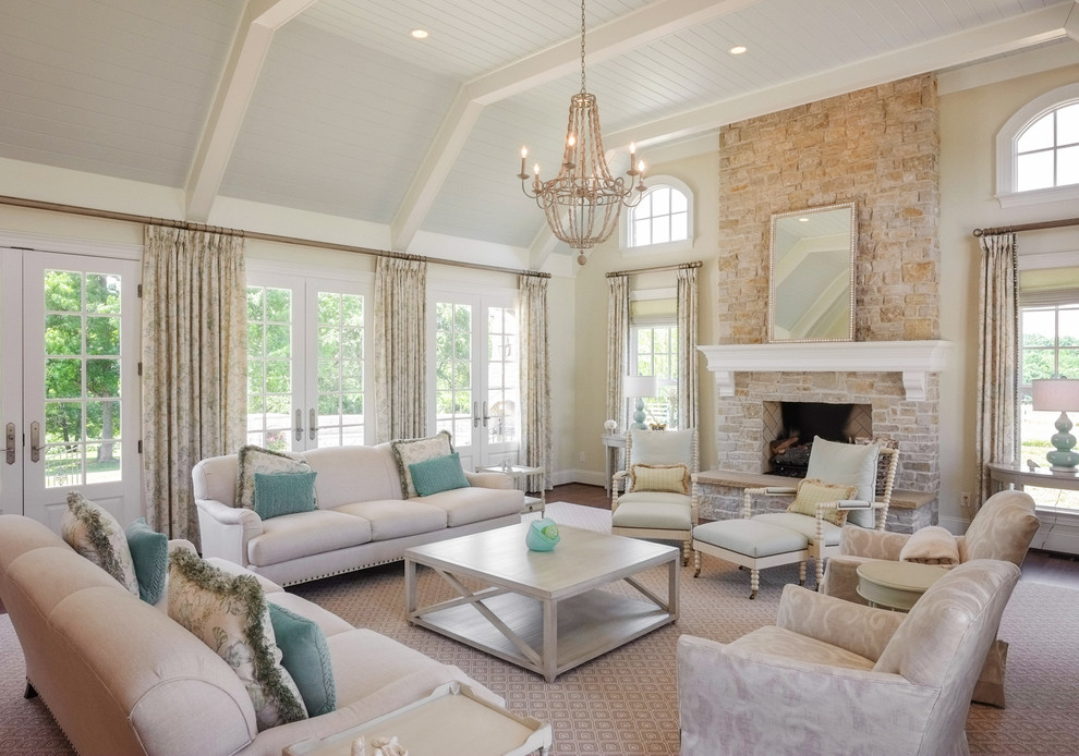 Inspiration for a traditional living room in Other with beige walls, dark hardwood flooring, a standard fireplace, a stone fireplace surround and feature lighting.