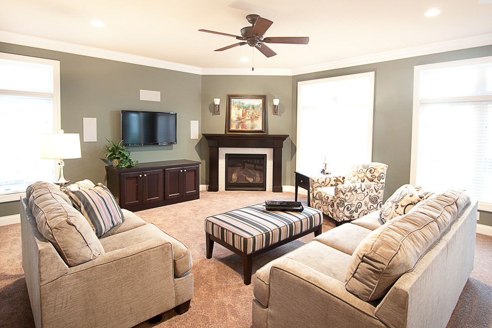 Photo of a traditional living room in Milwaukee with green walls, a corner fireplace, a tiled fireplace surround and a built-in media unit.