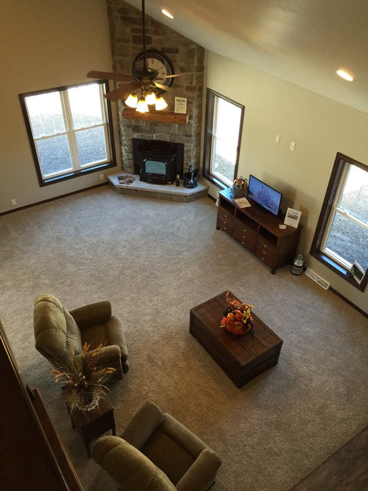 Mid-sized country open concept carpeted living room photo in Other with a corner fireplace and a stone fireplace