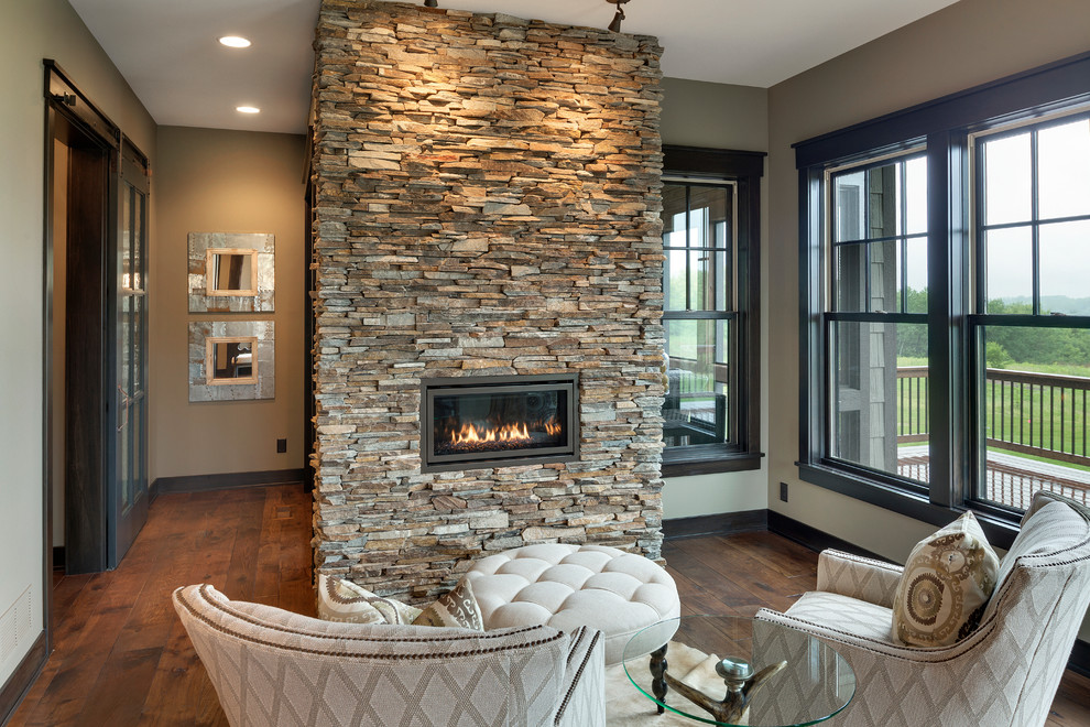 Medium tone wood floor living room photo in Minneapolis with a standard fireplace and a stone fireplace