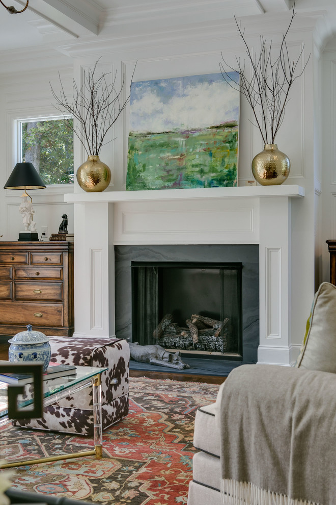 Inspiration for a transitional dark wood floor living room remodel in Raleigh with white walls and a standard fireplace