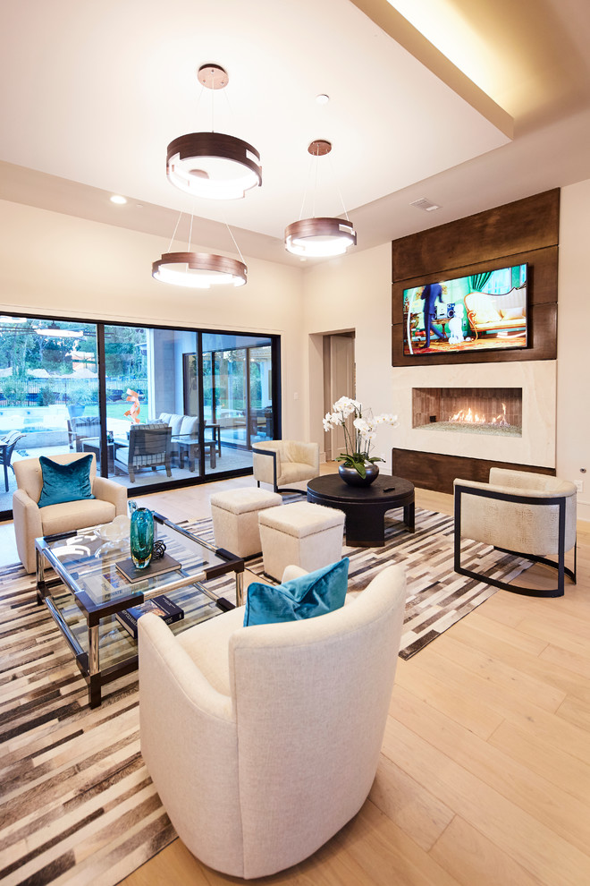 This is an example of a large contemporary open plan living room in Dallas with white walls, light hardwood flooring, a ribbon fireplace, a stone fireplace surround, a wall mounted tv and beige floors.
