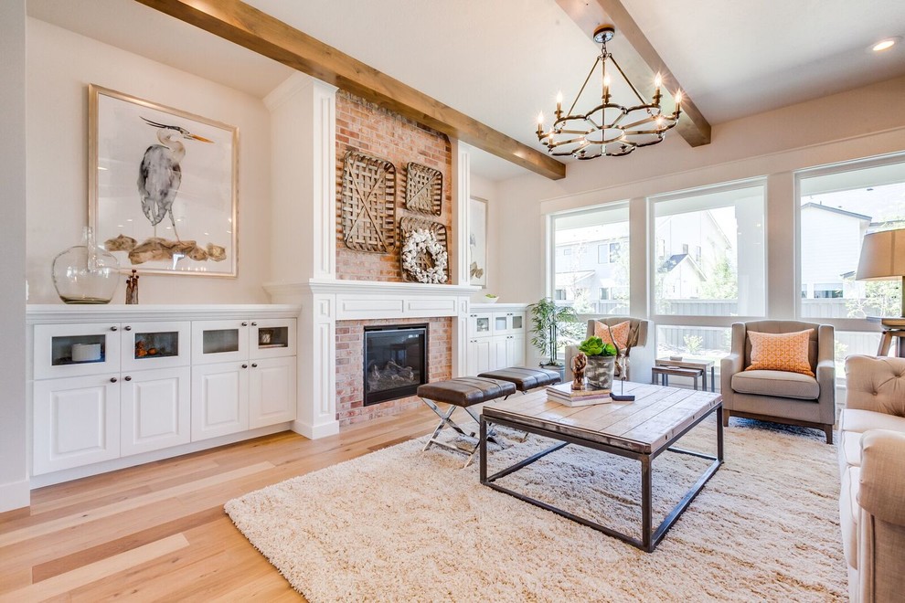 Photo of a medium sized traditional formal enclosed living room in Boise with beige walls, light hardwood flooring, a standard fireplace, a brick fireplace surround, no tv and brown floors.
