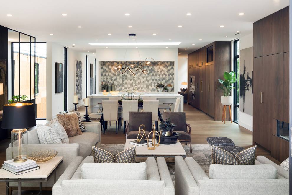 Large minimalist open concept light wood floor and gray floor living room photo in Minneapolis with white walls, a ribbon fireplace, a wood fireplace surround and a concealed tv