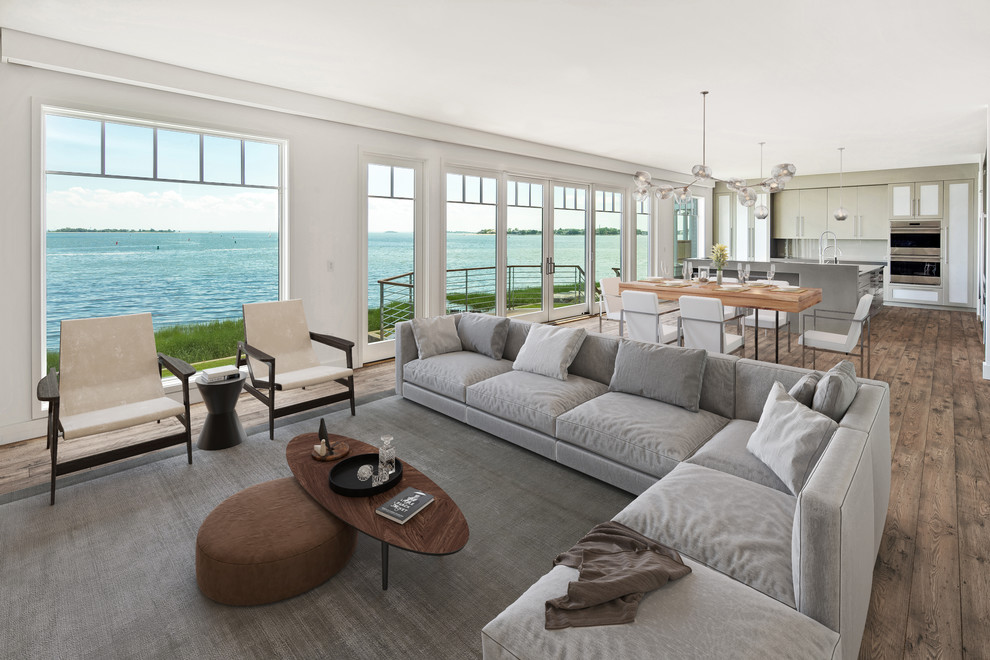 Immagine di un soggiorno costiero con pareti bianche, parquet scuro e pavimento marrone