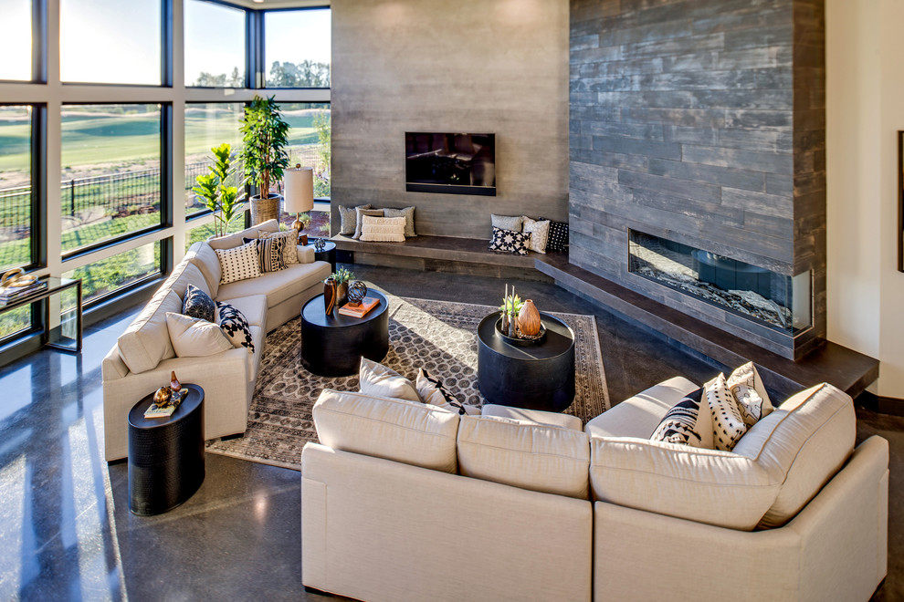 Photo of a large contemporary formal open plan living room in Portland with multi-coloured walls, concrete flooring, a corner fireplace, a tiled fireplace surround, a wall mounted tv and grey floors.