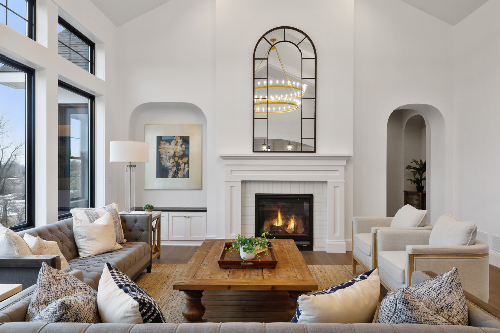 Living room - transitional formal and open concept medium tone wood floor, brown floor and vaulted ceiling living room idea in Minneapolis with a standard fireplace, a brick fireplace and no tv