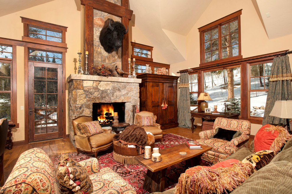 Inspiration for a timeless living room remodel in Denver with beige walls, a standard fireplace and a stone fireplace