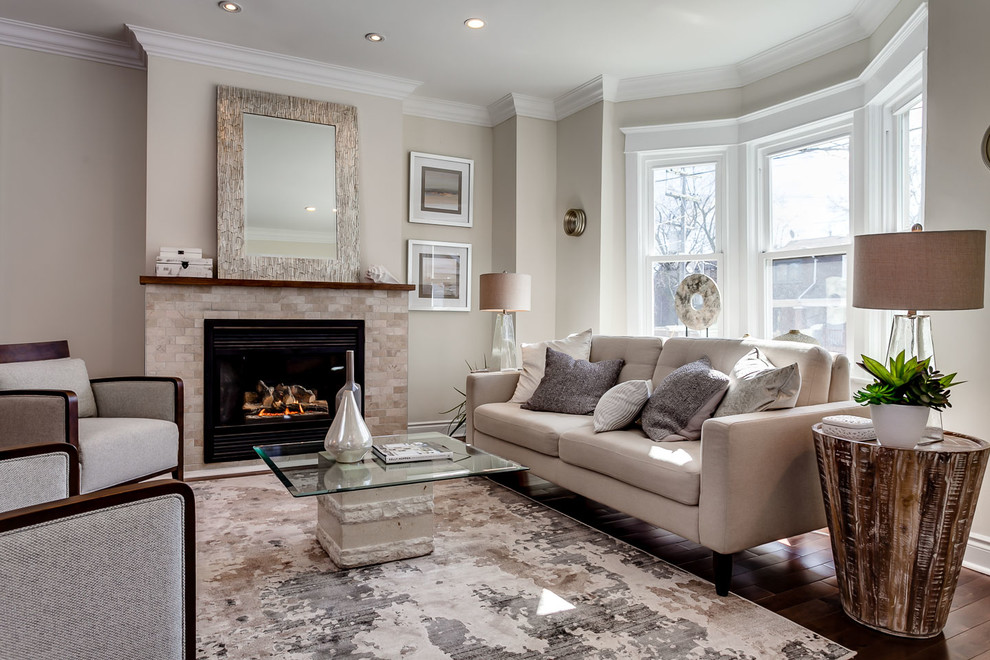 Living room - transitional light wood floor living room idea in Toronto with gray walls and a standard fireplace
