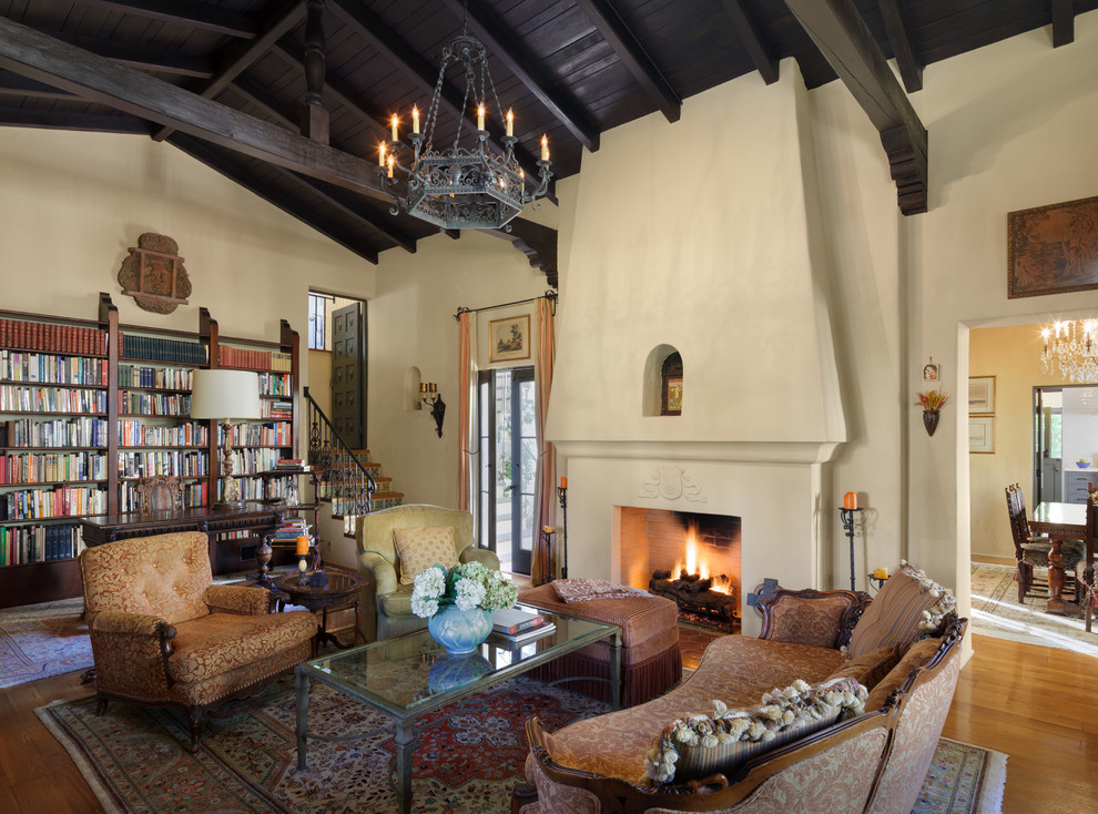 Mediterranean living room in Los Angeles with a reading nook, medium hardwood flooring and a standard fireplace.