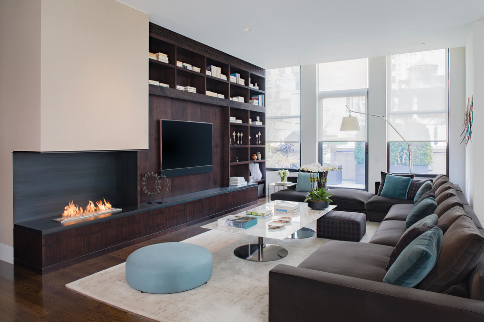 Inspiration for a large contemporary open plan living room in New York with white walls, medium hardwood flooring, a corner fireplace, a metal fireplace surround, a built-in media unit and brown floors.