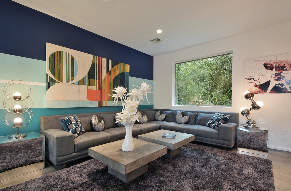Example of a trendy formal concrete floor living room design in Austin with multicolored walls, no fireplace and no tv