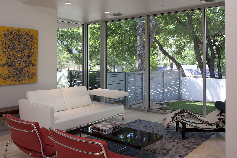 This is an example of a modern living room in Austin with white walls.