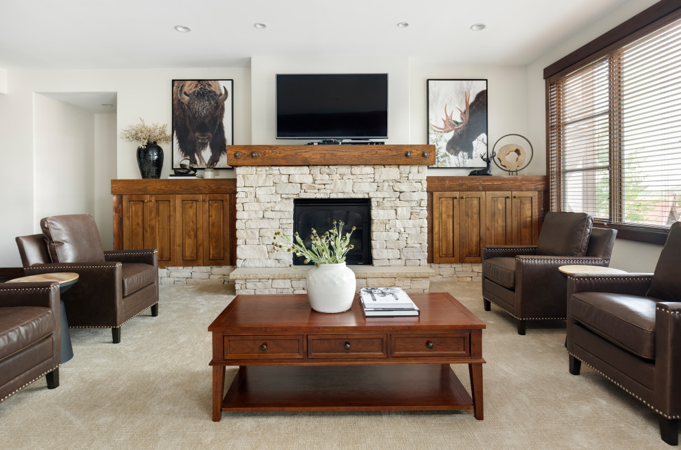 Large mountain style carpeted and beige floor living room photo in Salt Lake City with white walls, a standard fireplace, a stone fireplace and a wall-mounted tv