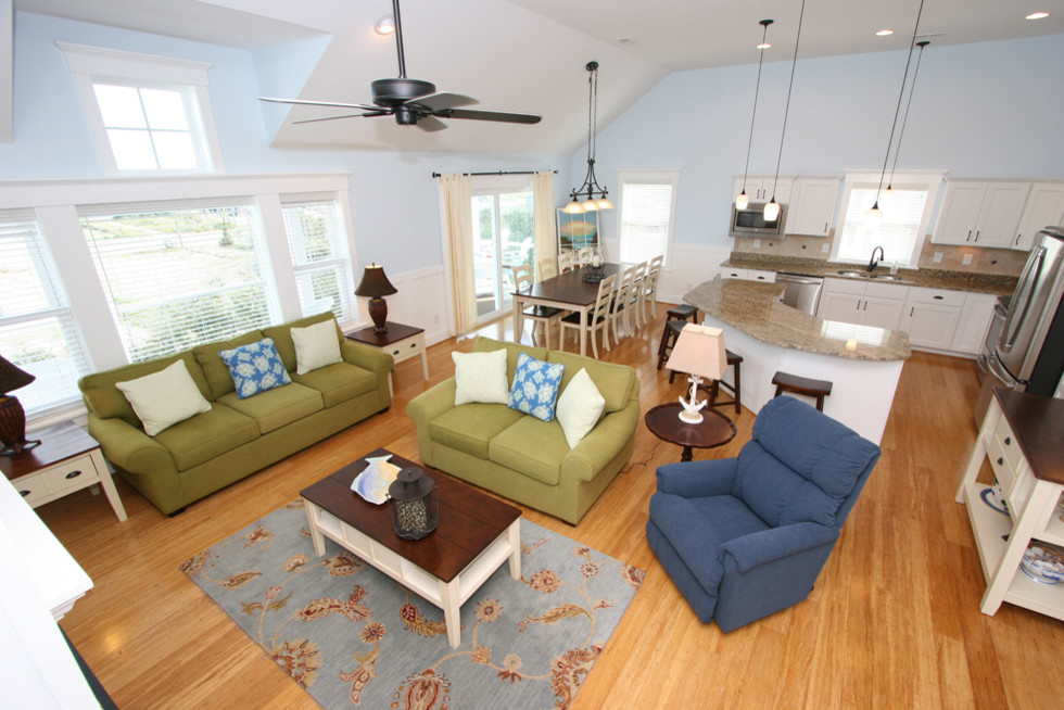Example of a mid-sized beach style formal and enclosed medium tone wood floor living room design in Other with blue walls, a standard fireplace, a plaster fireplace and a wall-mounted tv