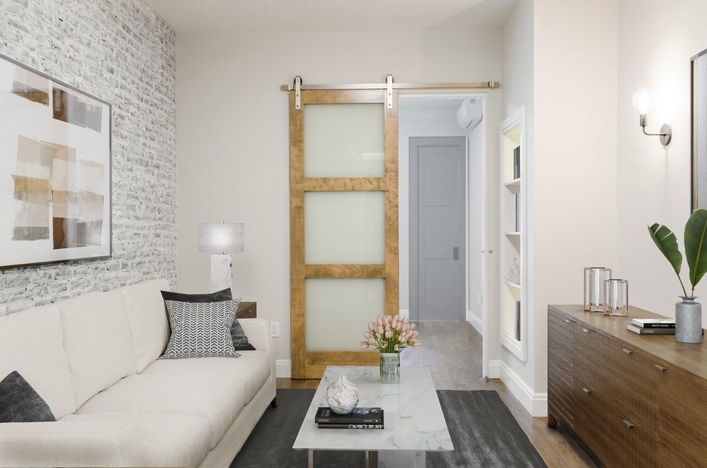 Living room - scandinavian enclosed light wood floor living room idea in New York with beige walls and no fireplace