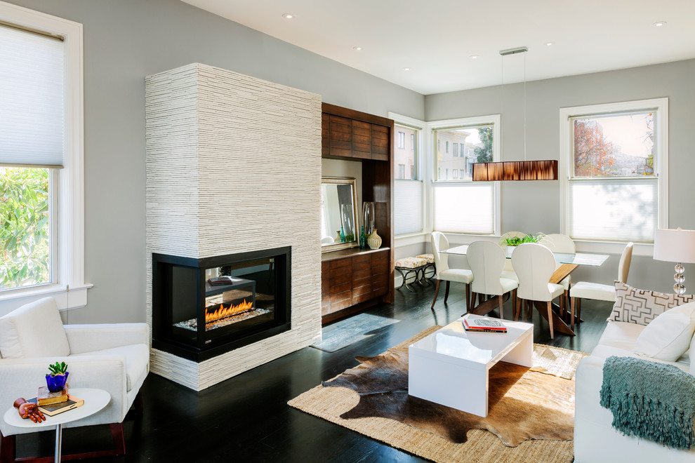 Living room - contemporary formal and open concept dark wood floor and black floor living room idea in San Francisco with a two-sided fireplace, gray walls, a tile fireplace and a media wall