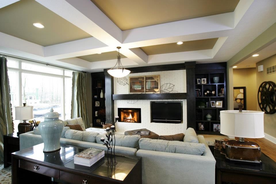 Inspiration for a classic open plan living room in Indianapolis with beige walls, light hardwood flooring, a standard fireplace, a brick fireplace surround and a built-in media unit.