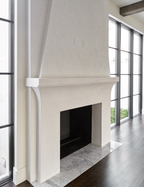 This is an example of a large contemporary living room in Dallas with white walls, dark hardwood flooring, a standard fireplace and a concrete fireplace surround.