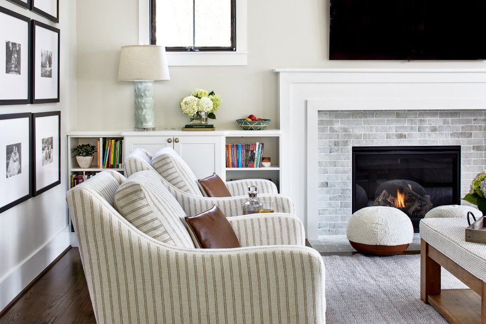 Photo of a medium sized classic living room in Delhi with grey walls, dark hardwood flooring, a standard fireplace, a stone fireplace surround, a wall mounted tv and brown floors.