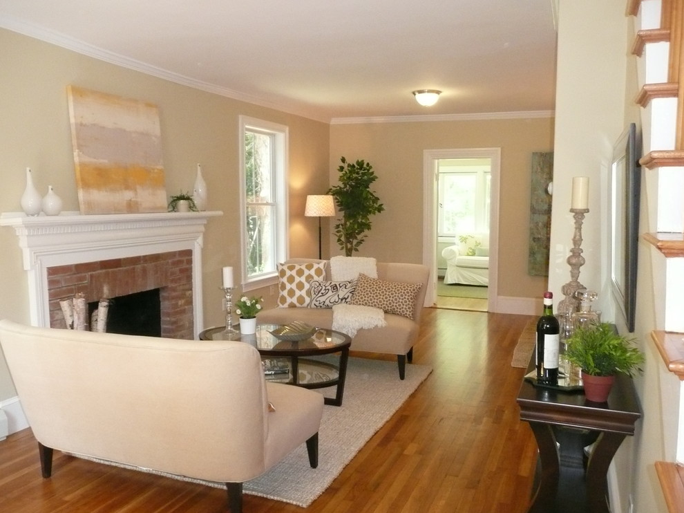 Photo of a small classic enclosed living room in Boston with beige walls, medium hardwood flooring, a standard fireplace and a brick fireplace surround.