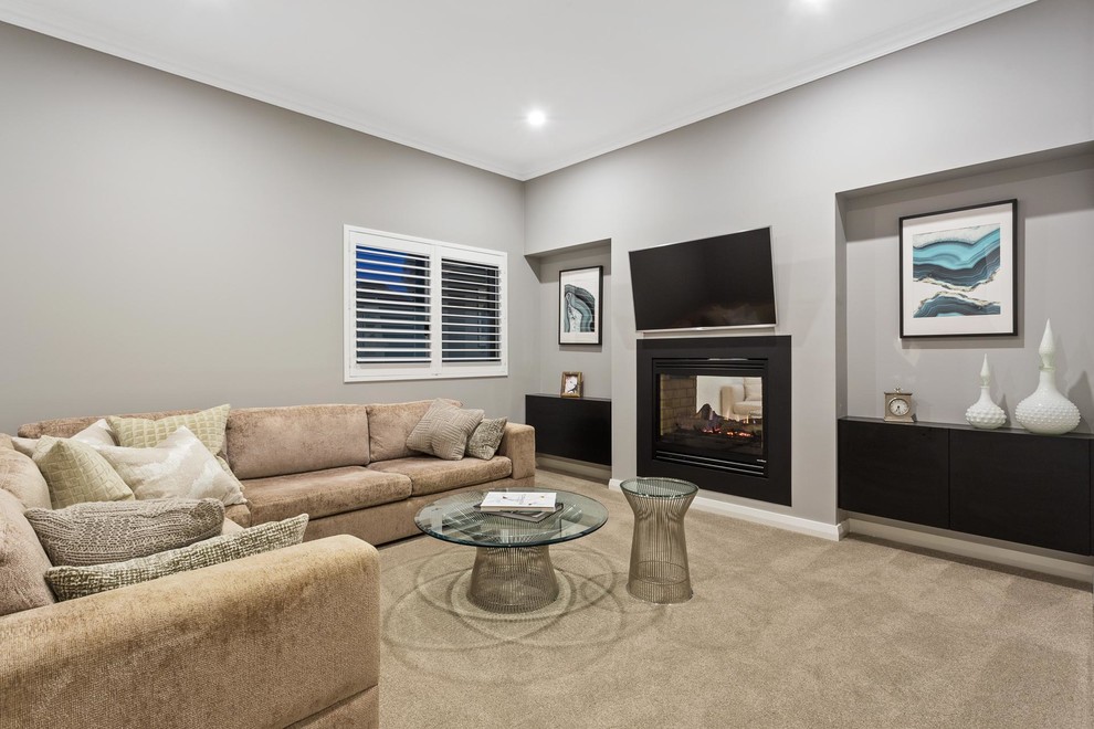 Beach style formal enclosed living room in Perth with grey walls, carpet, a two-sided fireplace, a metal fireplace surround, a wall mounted tv and beige floors.