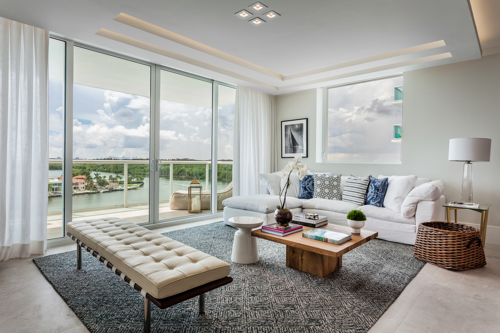 Example of a large trendy enclosed porcelain tile and beige floor living room design in Miami with gray walls