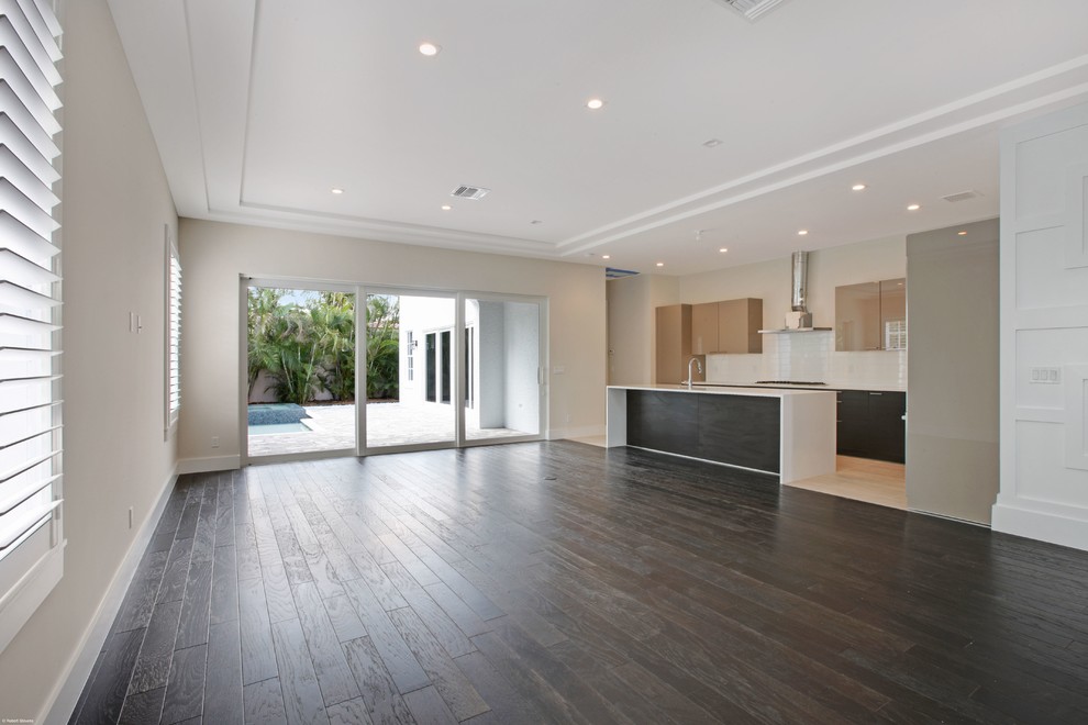 Large mediterranean open plan living room in Miami with dark hardwood flooring.