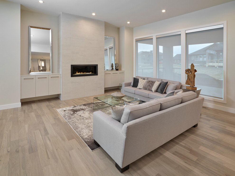 Large contemporary open plan living room in Edmonton with beige walls and no tv.