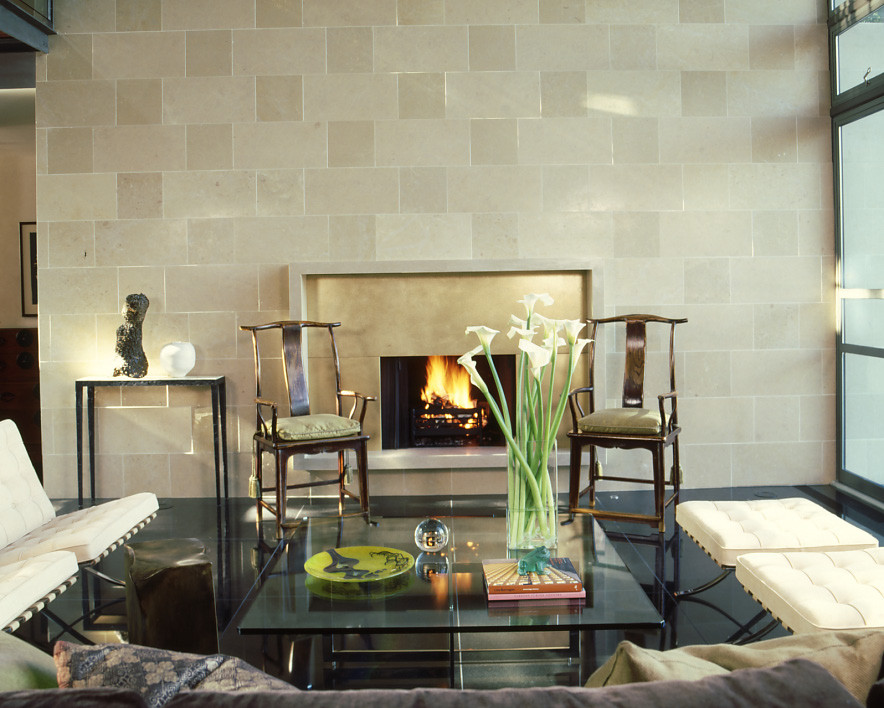 На фото: гостиная комната среднего размера в современном стиле с полом из керамогранита, стандартным камином, фасадом камина из камня и черным полом с