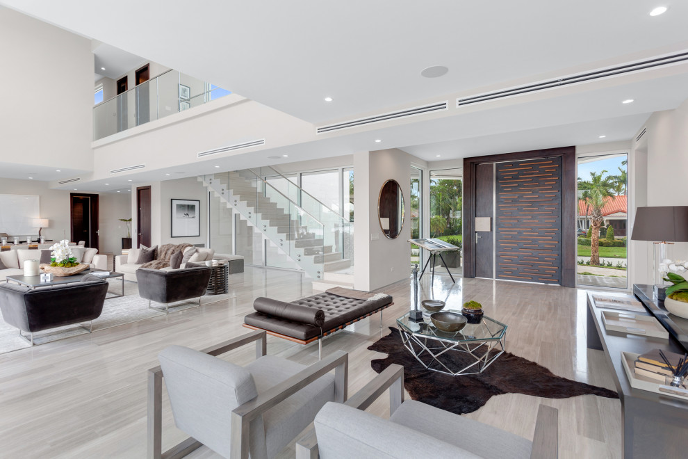 Foto di un grande soggiorno design aperto con pavimento grigio e pareti bianche