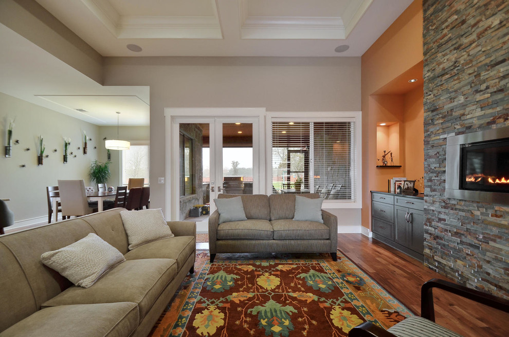 Mid-sized transitional open concept medium tone wood floor living room photo in Austin with a ribbon fireplace, a stone fireplace and no tv