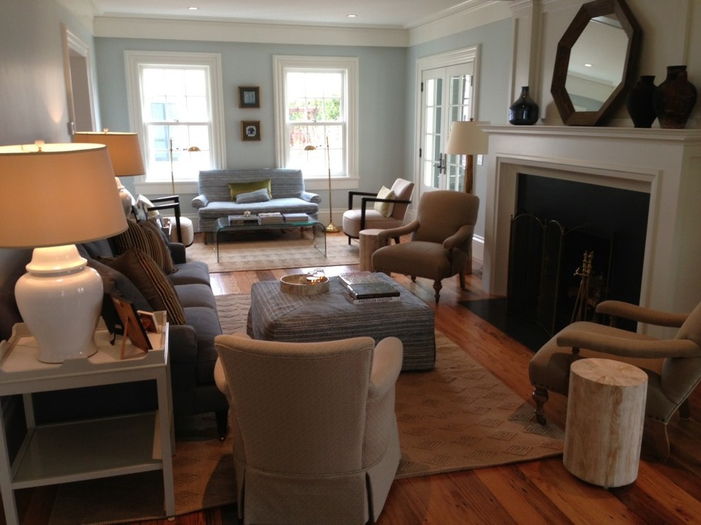 Inspiration for a medium sized classic formal enclosed living room in Boston with blue walls, medium hardwood flooring, a standard fireplace, a wooden fireplace surround, no tv and brown floors.