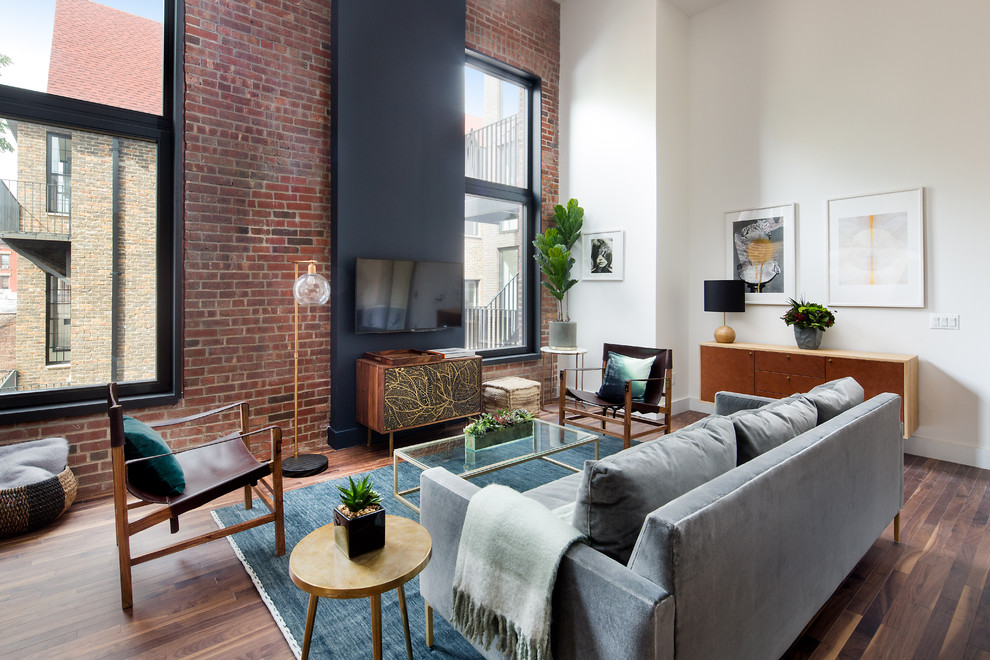 This is an example of a contemporary living room in New York with white walls, dark hardwood flooring, no fireplace and brown floors.